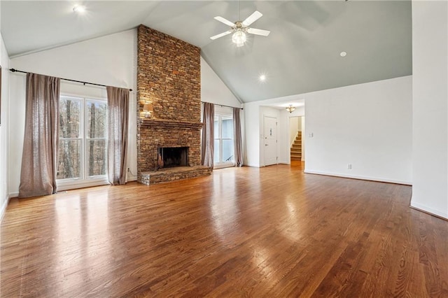 unfurnished living room with ceiling fan, a fireplace, high vaulted ceiling, and wood-type flooring