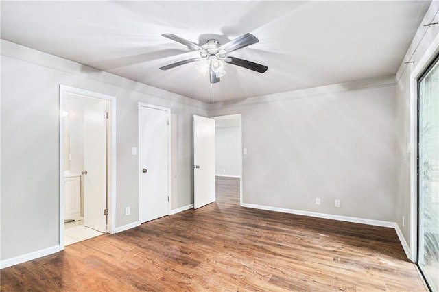532 Watson St, Toccoa, GA 30577 - unfurnished bedroom with wood finished floors, connected bathroom, and a ceiling fan