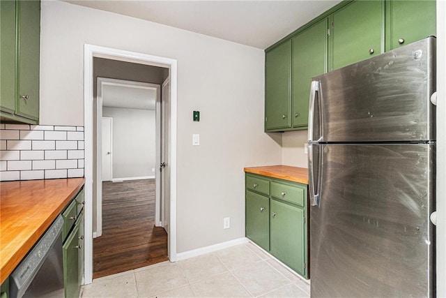 532 Watson St, Toccoa, GA 30577 - kitchen with stainless steel appliances, green cabinetry, butcher block countertops, decorative backsplash, and light tile patterned flooring