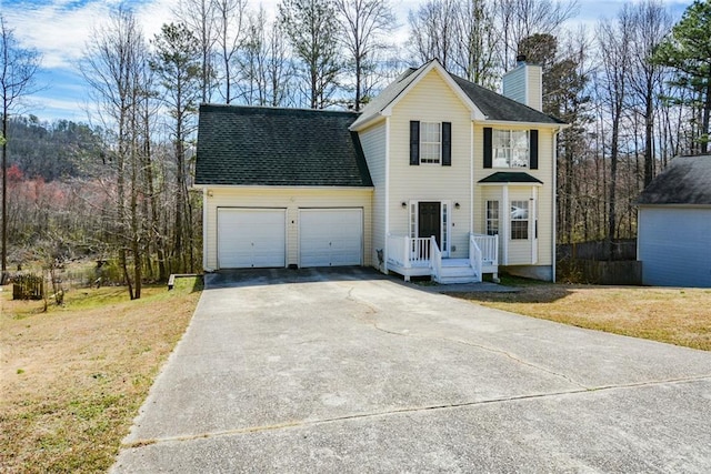 view of front of property featuring a front yard, a shingled roof, a chimney, concrete driveway, and a garage