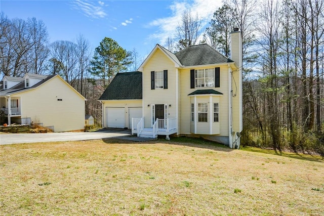 view of front facade featuring a garage, driveway, a chimney, and a front lawn