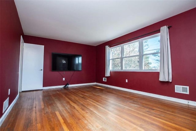 spare room with hardwood / wood-style floors