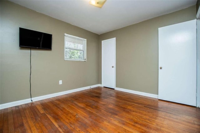 spare room with hardwood / wood-style floors