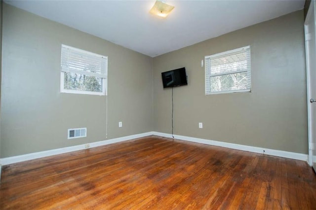 unfurnished room with hardwood / wood-style floors