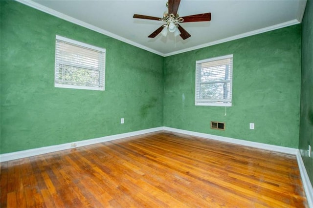 spare room with hardwood / wood-style flooring, crown molding, and ceiling fan