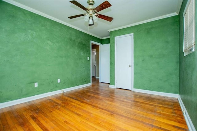 unfurnished bedroom featuring crown molding, ceiling fan, and hardwood / wood-style floors