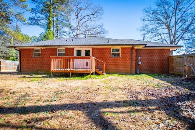 rear view of house featuring a wooden deck