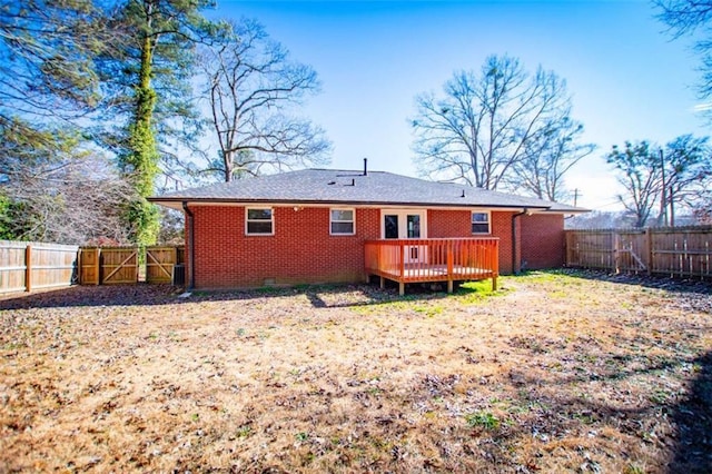 rear view of property with a wooden deck