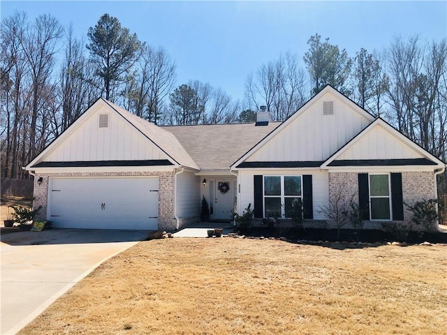 view of front of home featuring board and batten siding, concrete driveway, a garage, brick siding, and a chimney