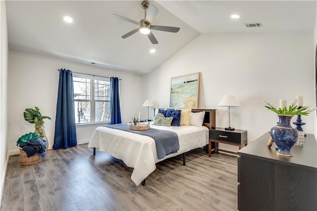 bedroom featuring recessed lighting, visible vents, light wood-style flooring, and vaulted ceiling