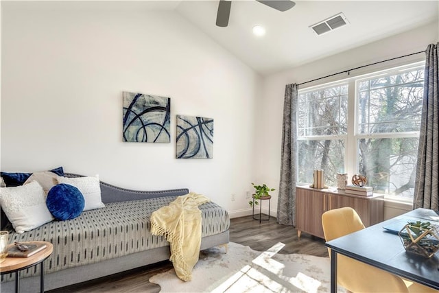 bedroom with visible vents, baseboards, lofted ceiling, wood finished floors, and a ceiling fan