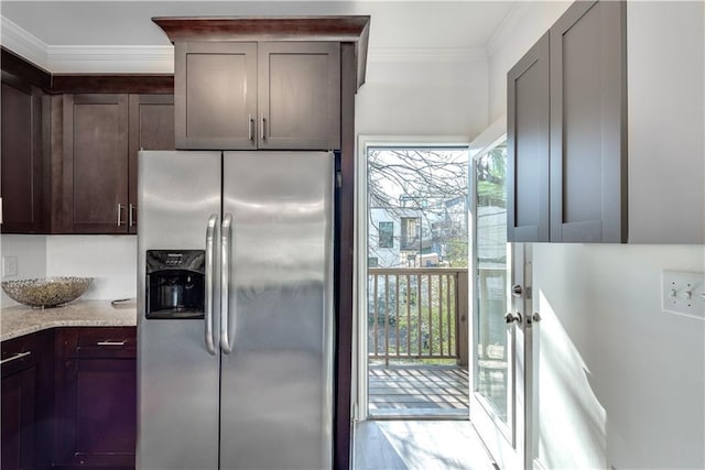 kitchen featuring stainless steel refrigerator with ice dispenser, ornamental molding, light stone counters, and dark brown cabinets