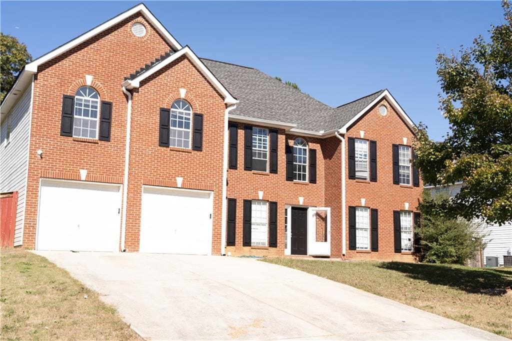 view of front facade with a front yard and a garage