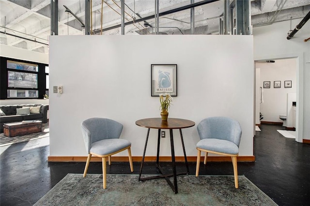 living area with a towering ceiling