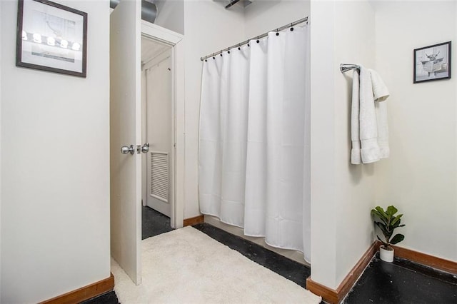 bathroom featuring concrete flooring and walk in shower