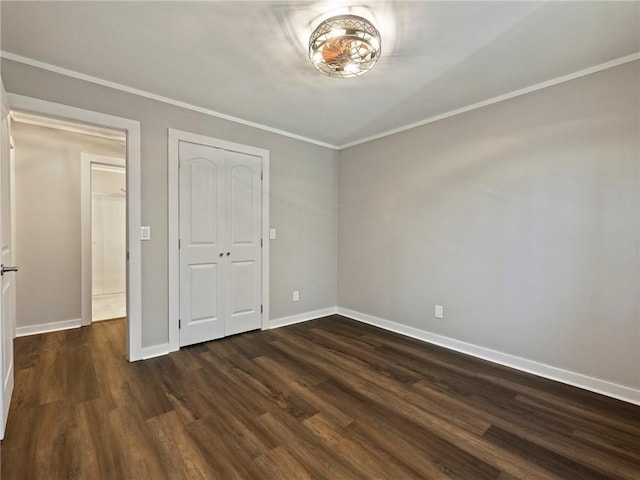 2938 Chestatee Rd, Gainesville, GA 30506 - unfurnished bedroom featuring baseboards, ornamental molding, dark wood-style floors, and a closet