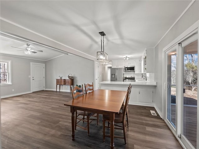 2938 Chestatee Rd, Gainesville, GA 30506 - dining space with crown molding, dark wood-style flooring, ceiling fan, baseboards, and visible vents