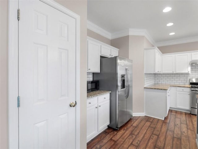 kitchen with stainless steel appliances, dark hardwood / wood-style flooring, white cabinets, and light stone counters