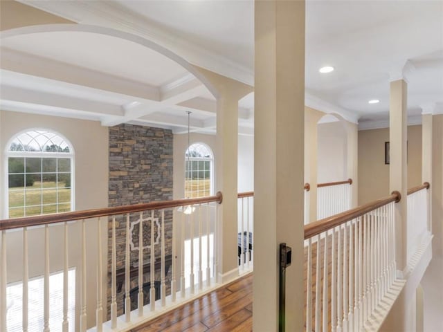 hall with coffered ceiling, hardwood / wood-style flooring, beam ceiling, and crown molding