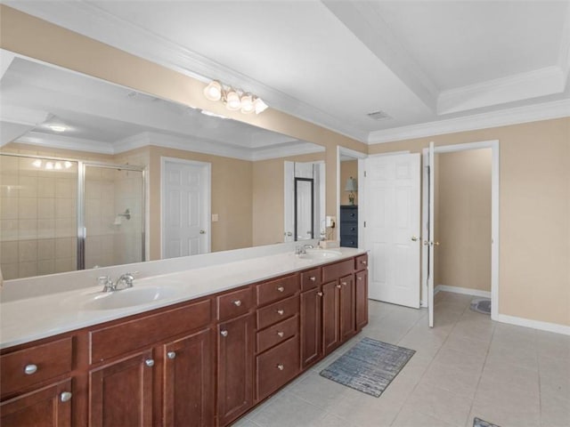 bathroom featuring tile patterned floors, ornamental molding, vanity, a raised ceiling, and a shower with door