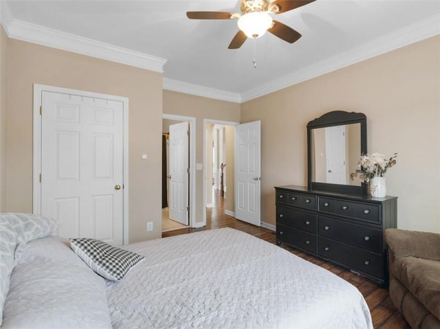 bedroom with dark wood-type flooring, ornamental molding, and ceiling fan