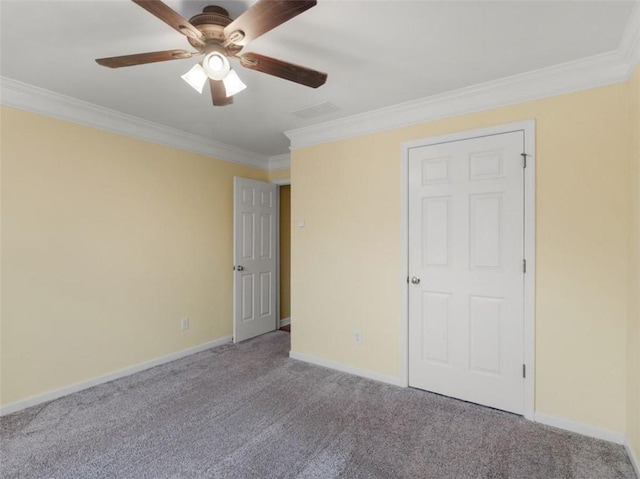 unfurnished bedroom featuring crown molding, ceiling fan, and carpet