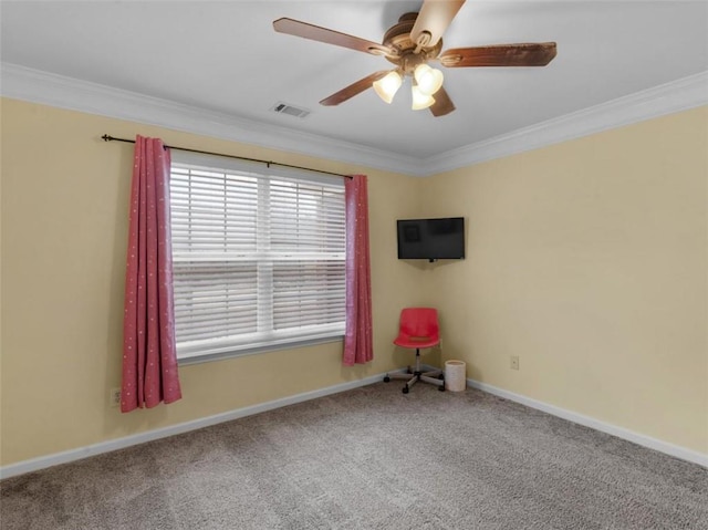 carpeted spare room featuring ornamental molding and ceiling fan