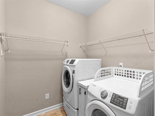 laundry area with light tile patterned floors and independent washer and dryer