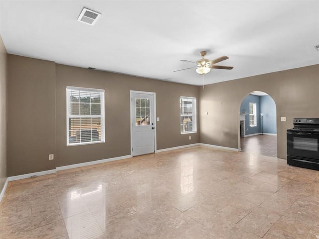 unfurnished living room with ceiling fan