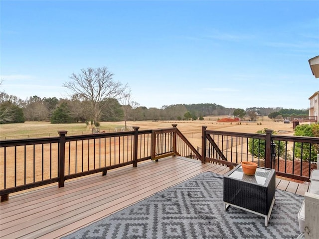 wooden deck with a rural view