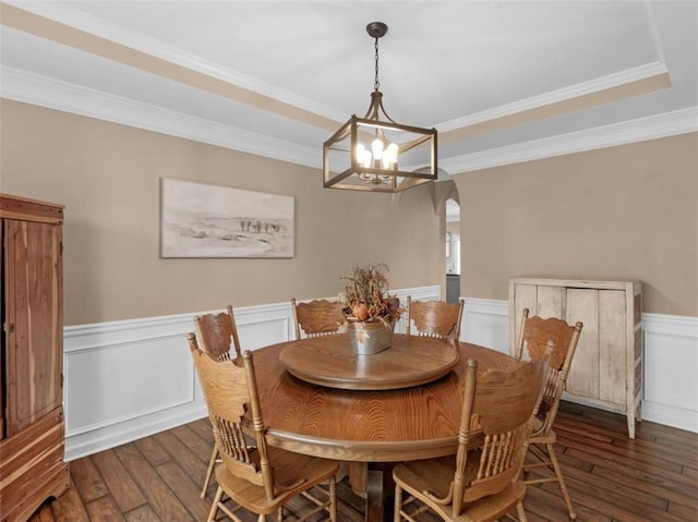 dining room with ornamental molding, dark hardwood / wood-style floors, and a chandelier