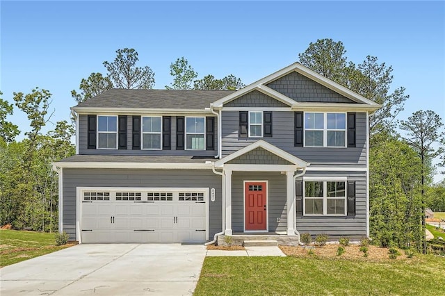 craftsman-style home featuring concrete driveway, an attached garage, and a front yard