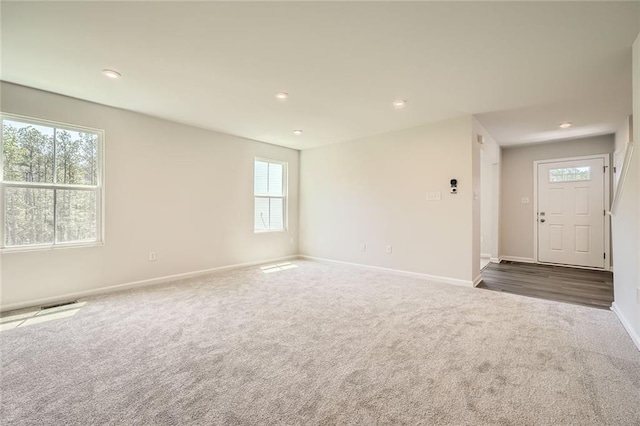spare room featuring carpet flooring, visible vents, baseboards, and recessed lighting