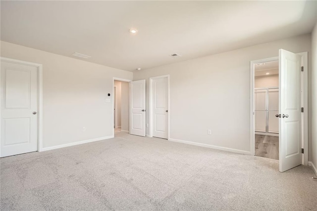 unfurnished bedroom with recessed lighting, baseboards, and carpet floors