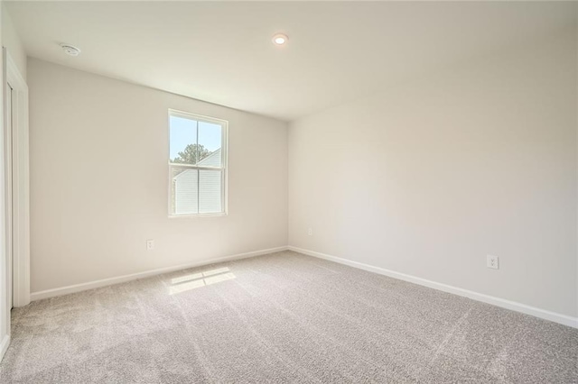 spare room with carpet floors and baseboards