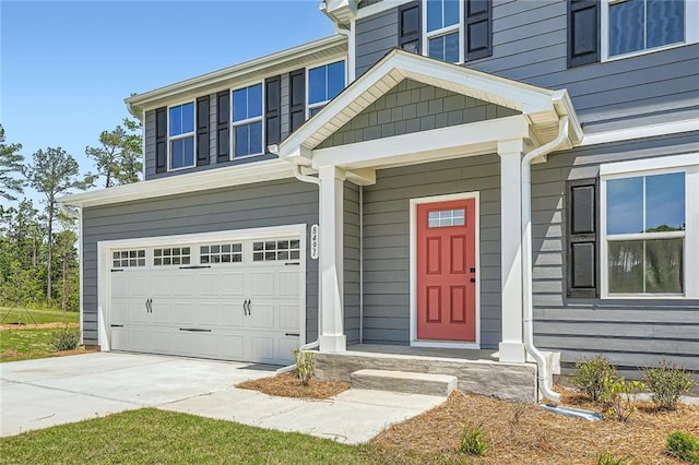 entrance to property with driveway and a garage