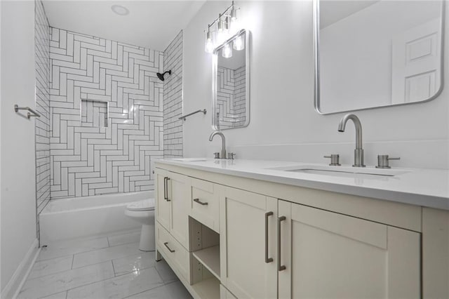 full bathroom with toilet, double vanity, marble look tiles, baseboards, and shower / bath combination