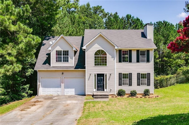 view of front of home with a garage and a front yard