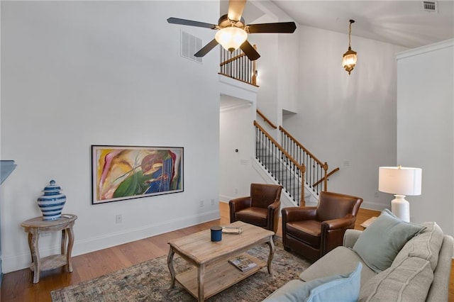 living room featuring wood-type flooring, ceiling fan, and high vaulted ceiling