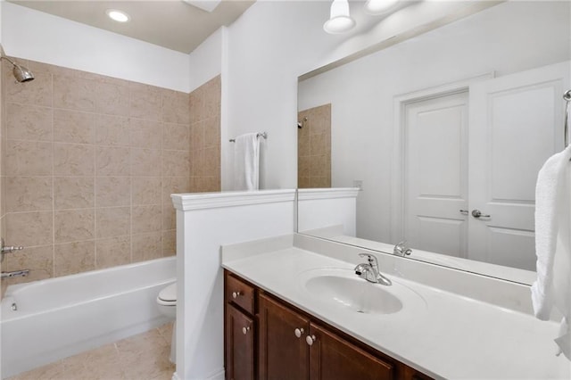 full bathroom with tiled shower / bath combo, vanity, tile patterned flooring, and toilet