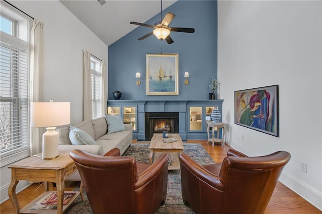 living area featuring hardwood / wood-style flooring, plenty of natural light, and vaulted ceiling