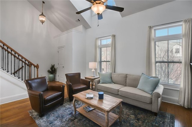 living room featuring ceiling fan, dark hardwood / wood-style floors, and high vaulted ceiling