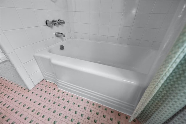 full bath featuring tile patterned floors, tile walls, a shower with shower curtain, and a bathing tub