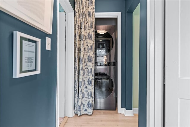 interior space featuring stacked washer and dryer and wood finished floors