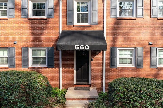 entrance to property with brick siding