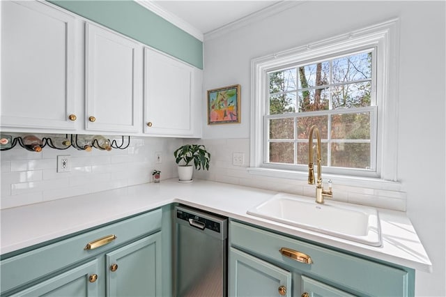 kitchen featuring dishwasher, ornamental molding, a sink, and white cabinets