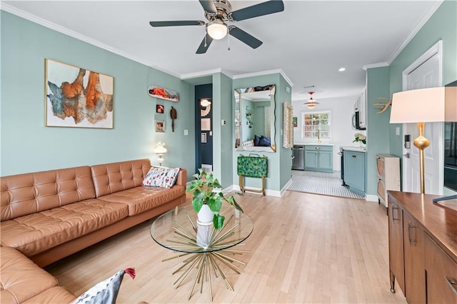 living area with a ceiling fan, light wood-type flooring, crown molding, and baseboards