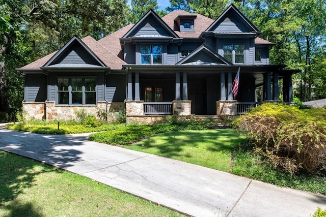 craftsman-style house with a porch and a front yard