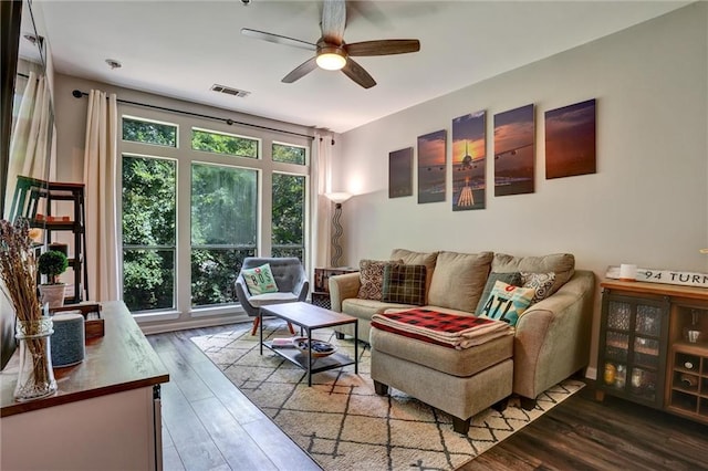 living room featuring ceiling fan, wood-type flooring, and a healthy amount of sunlight