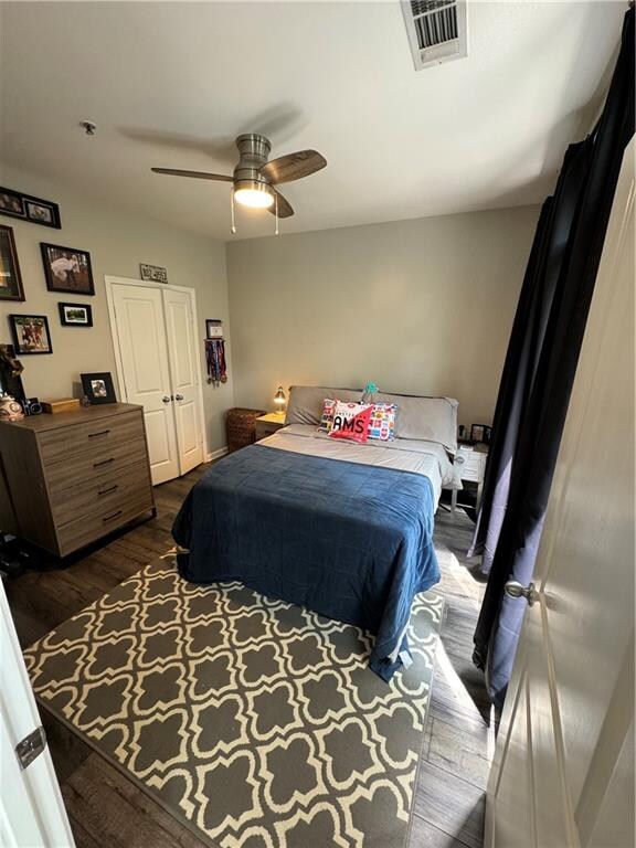 bedroom with ceiling fan and hardwood / wood-style floors